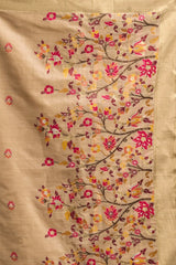 Beige fabric with floral embroidery in pink, red, and yellow on a beige background
