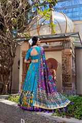 Women's sky blue Kalamkari saree with intricate traditional print, decorative border, and matching blouse.