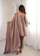 Woman wearing a traditional outfit with a long shawl in a minimalistic setting