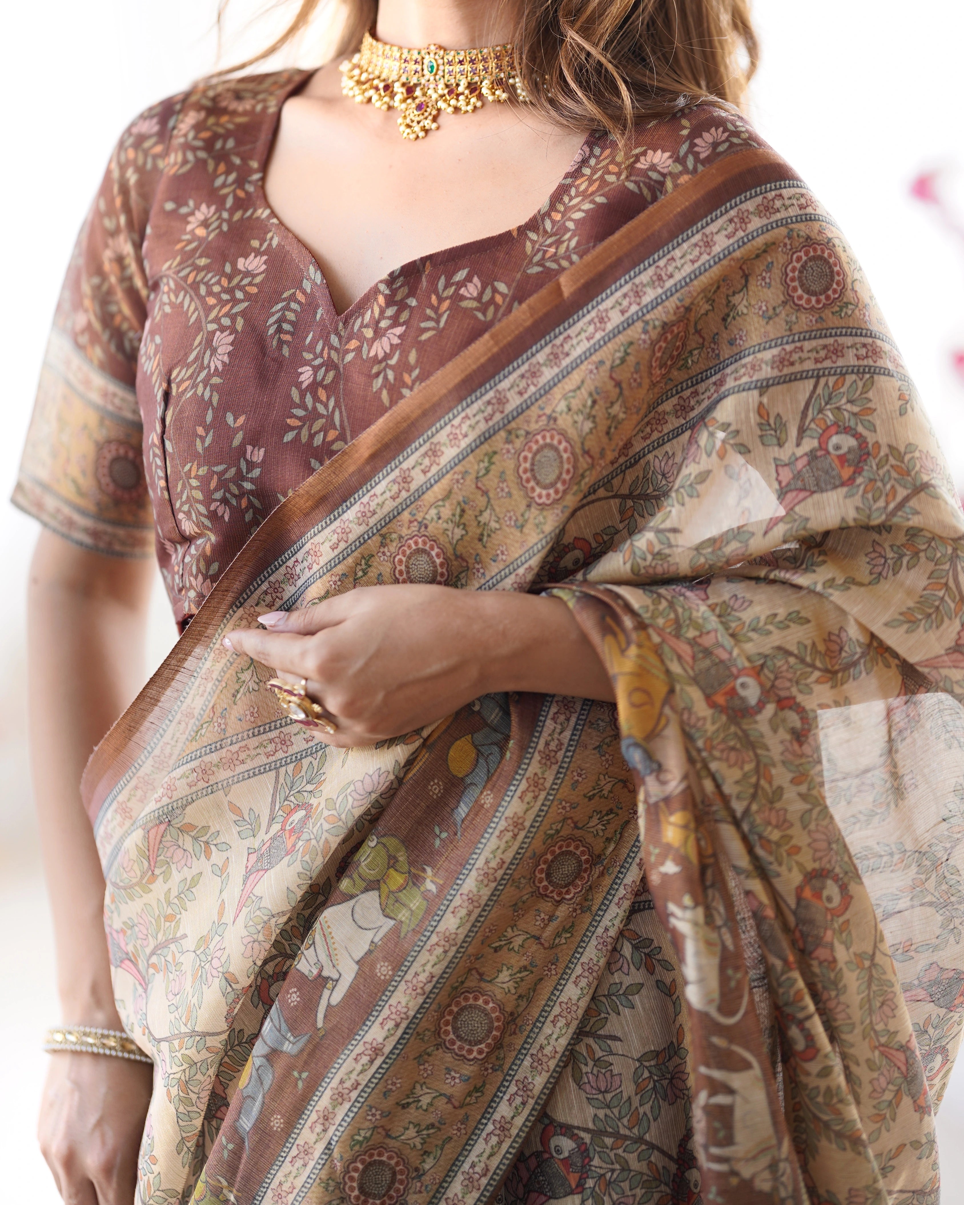 Woman wearing a patterned saree with a blurred background