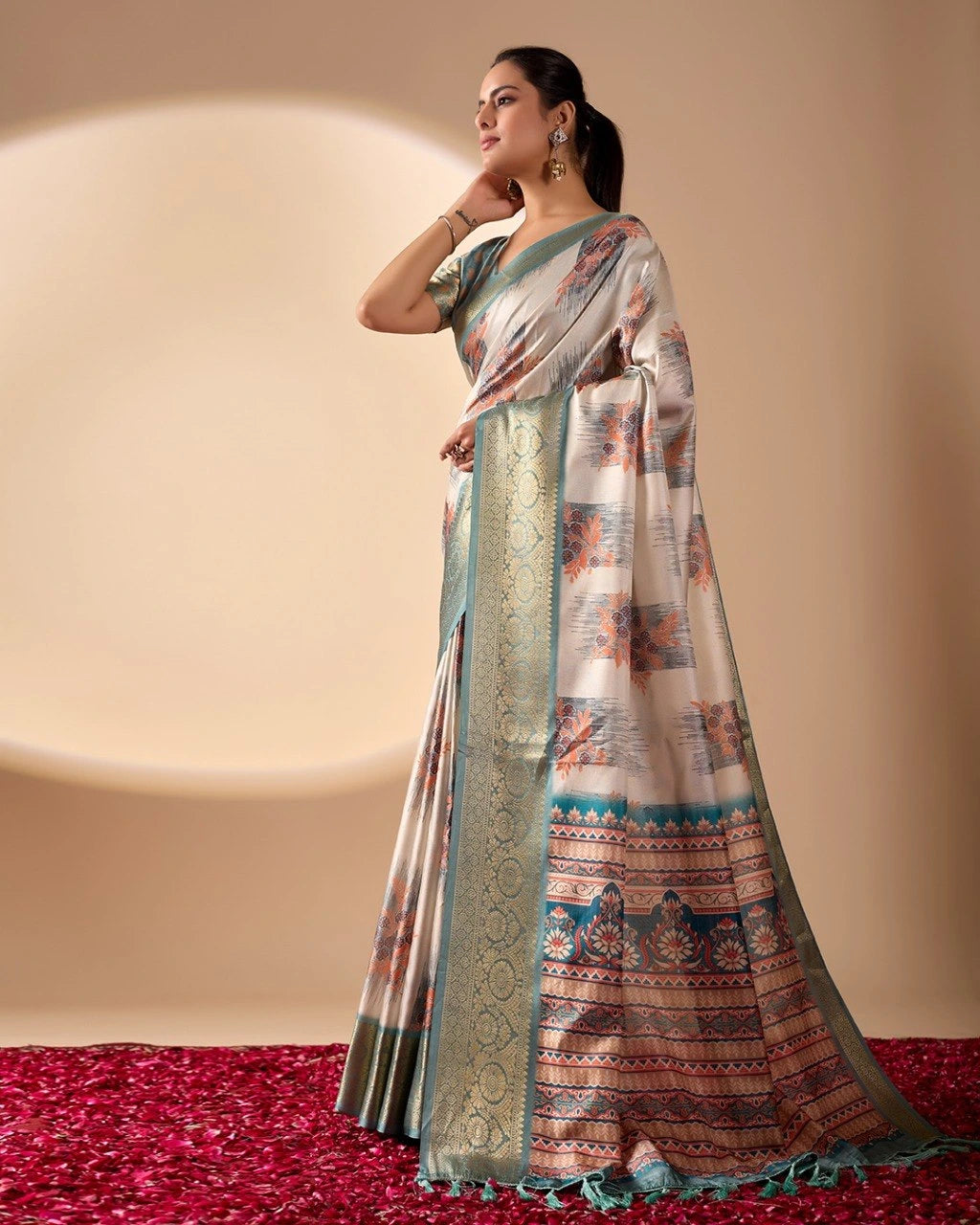 Woman wearing a traditional saree with a patterned design on a red and beige background