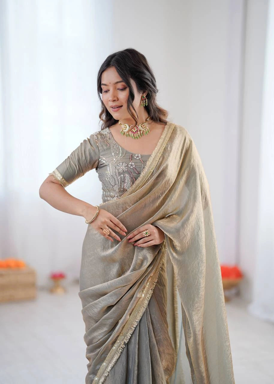 Woman wearing a saree with a plain background