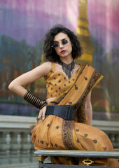 Woman in a yellow saree with a blurred background