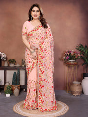 Woman wearing a floral saree in a decorated room with plants and decor items.