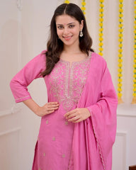 Woman wearing a pink traditional outfit with intricate designs.