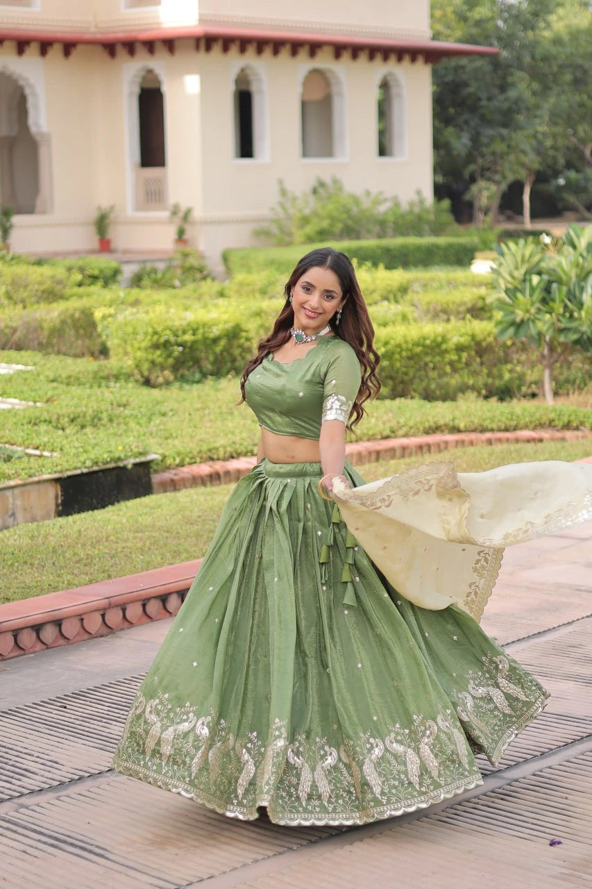 Woman in a green traditional outfit standing in a garden with a building in the background