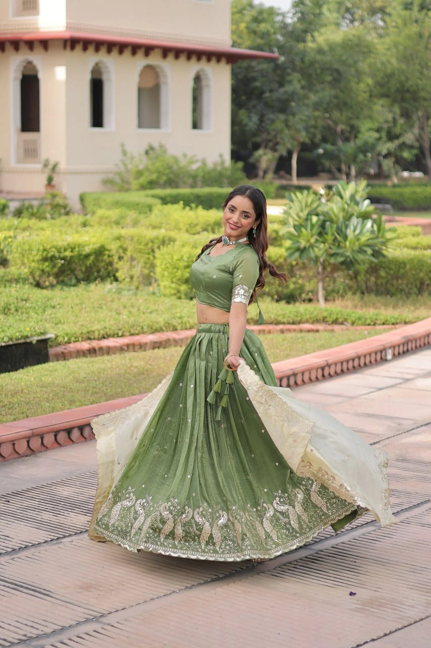 Woman in a green traditional outfit standing in a garden