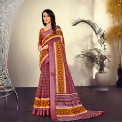 Woman in a maroon traditional printed pattern saree standing indoors with potted plants and modern decor in the background