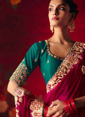 Woman wearing a traditional embroidered saree with a red background