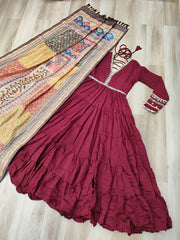 Maroon dress with intricate designs on a wooden floor