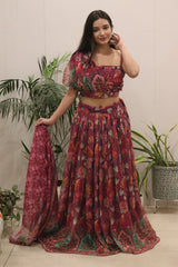 Woman wearing a floral two-piece outfit with plants in the background