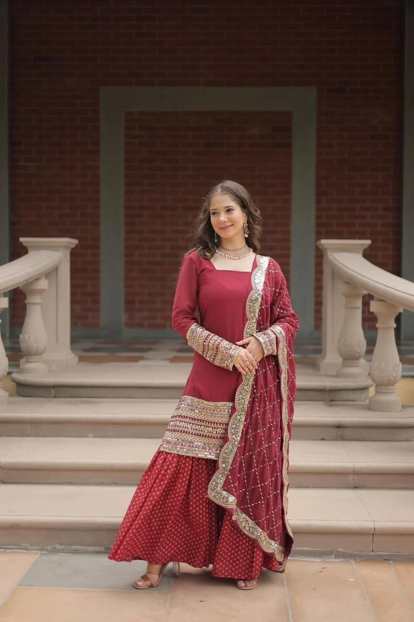 Woman in a red traditional outfit standing on steps with a brick wall background