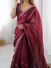 Maroon saree with silver embroidery on a plain background