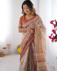 Woman wearing a floral saree with a white background and decorative elements.