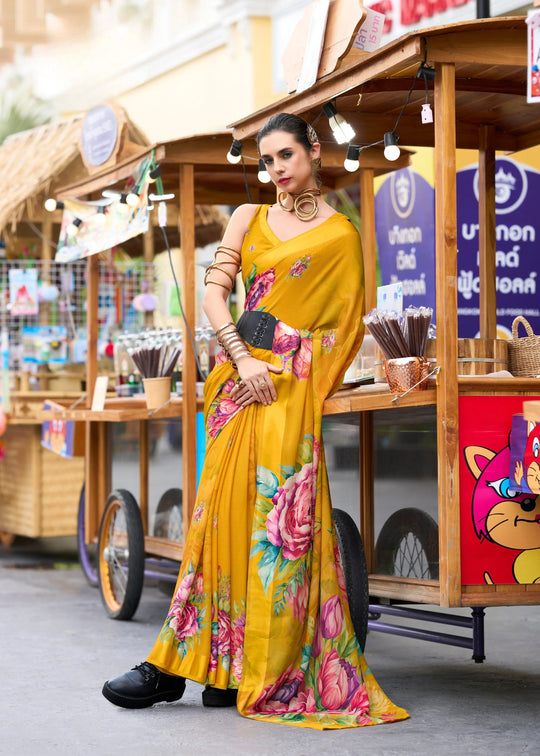 Woman in a yellow floral dress standing in front of a food cart.