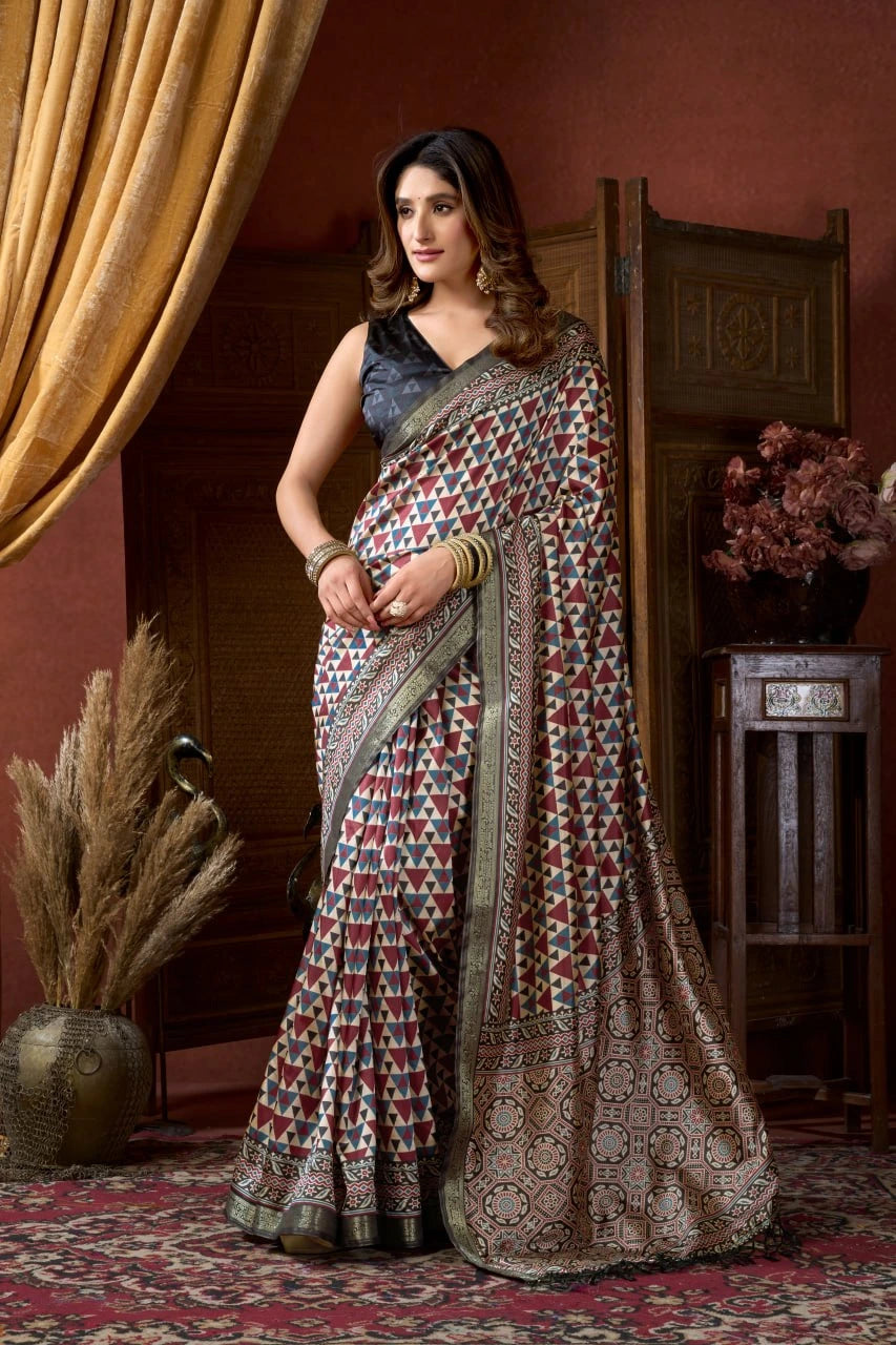 Woman wearing a traditional saree in a decorative indoor setting