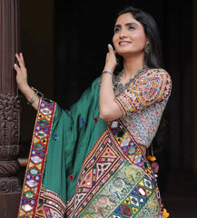 Woman wearing a colorful traditional outfit with a green background