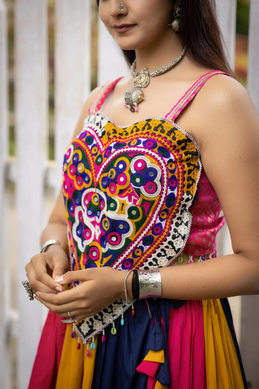 Woman wearing a colorful traditional outfit with intricate patterns.