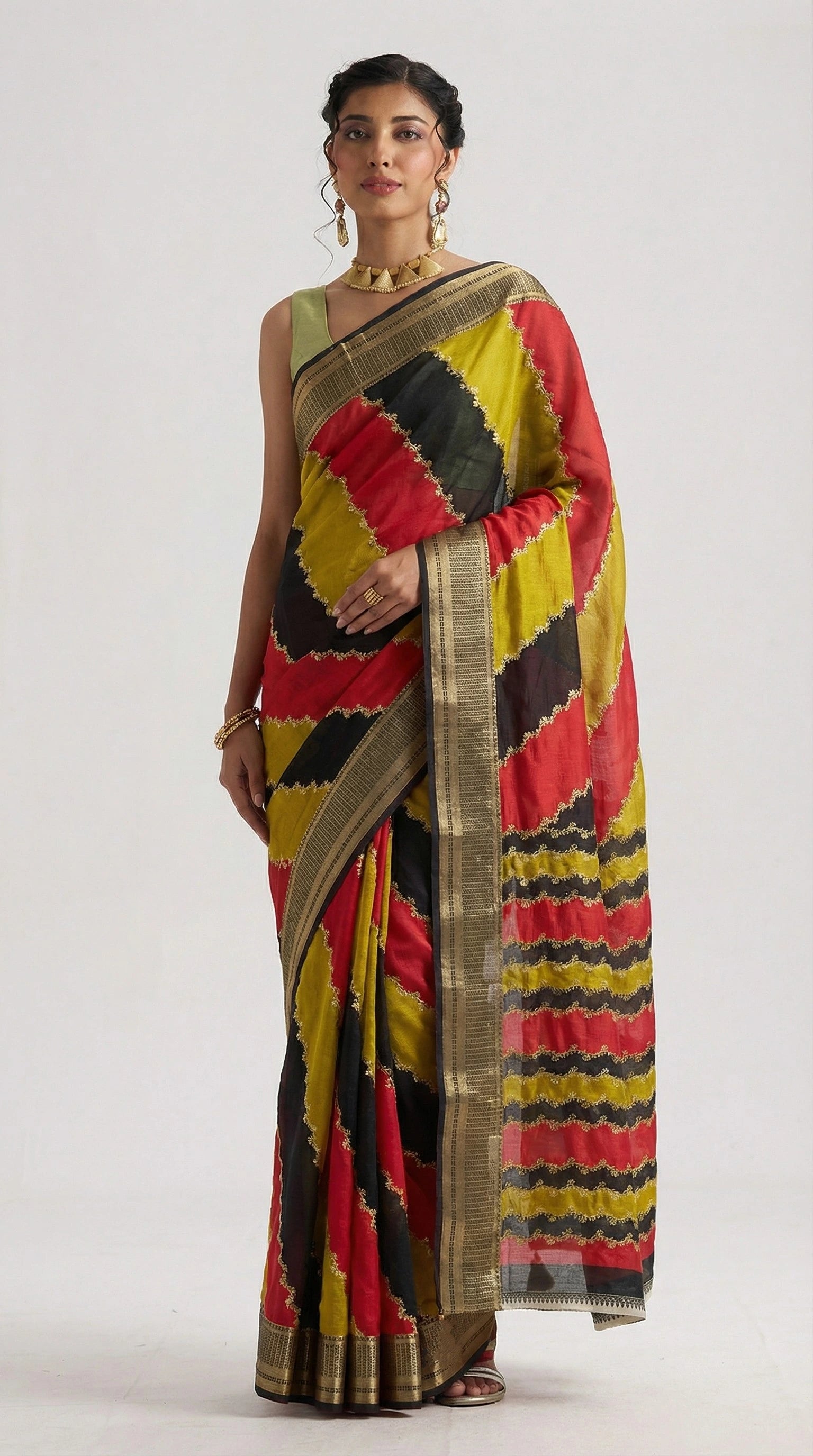 Woman wearing a colorful saree with a geometric pattern on a white background