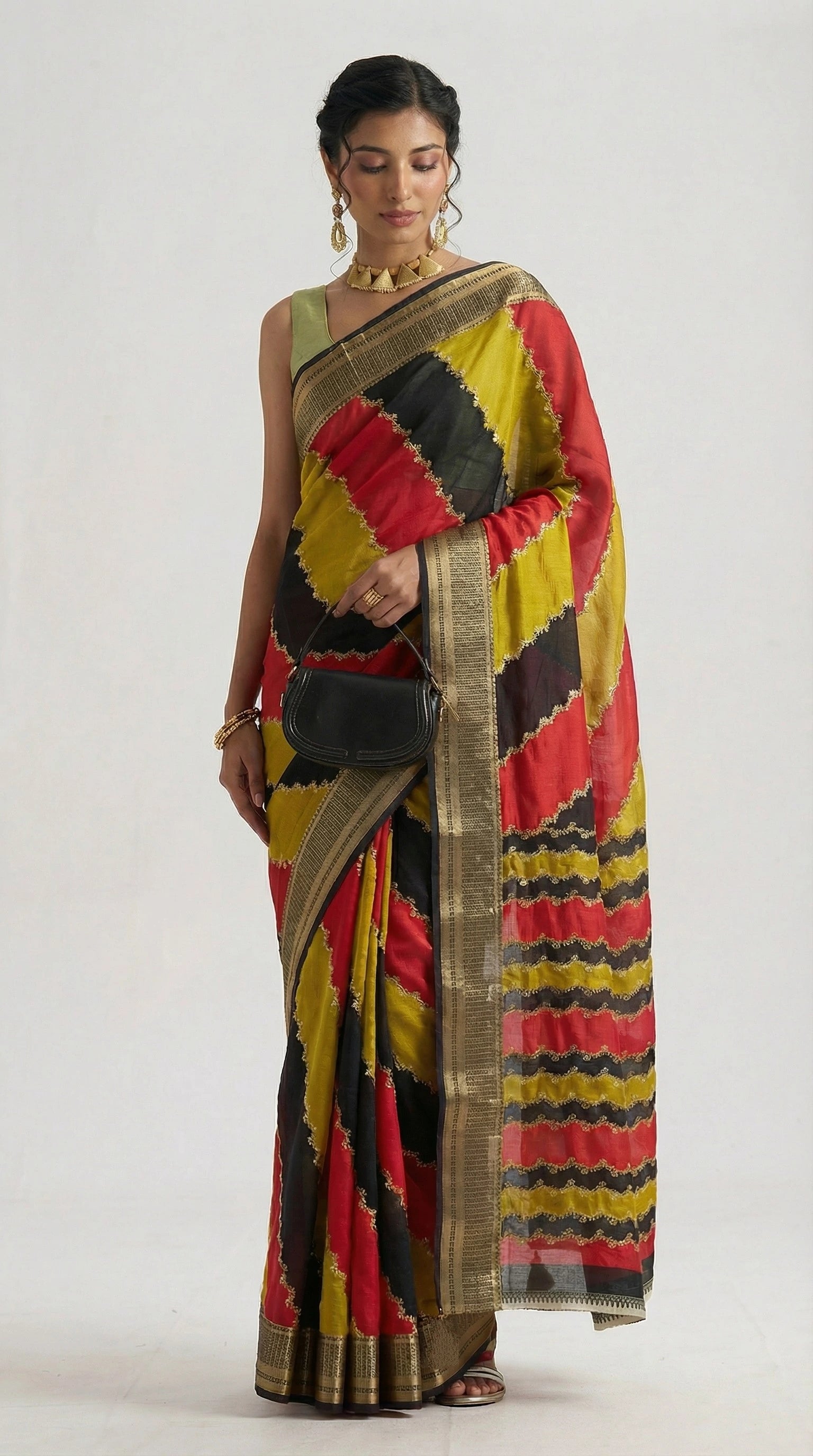 Woman wearing a colorful saree with a geometric pattern on a white background