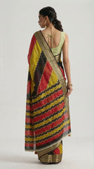 Woman wearing a colorful saree with a plain background