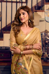 Woman in a yellow saree with floral patterns in an indoor setting