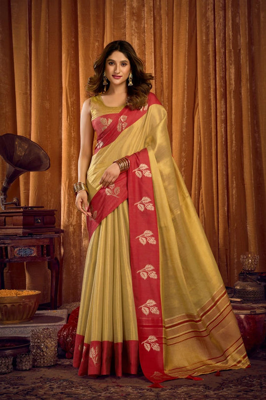 Woman wearing a yellow and red saree with a vintage background