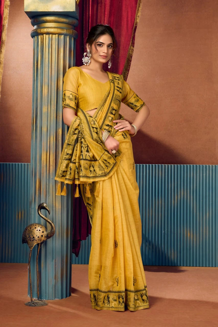 Woman in a yellow saree with gold patterns against a decorative background