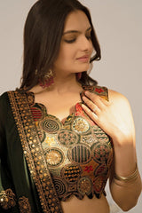 Woman wearing a traditional embroidered blouse with intricate patterns on a plain background