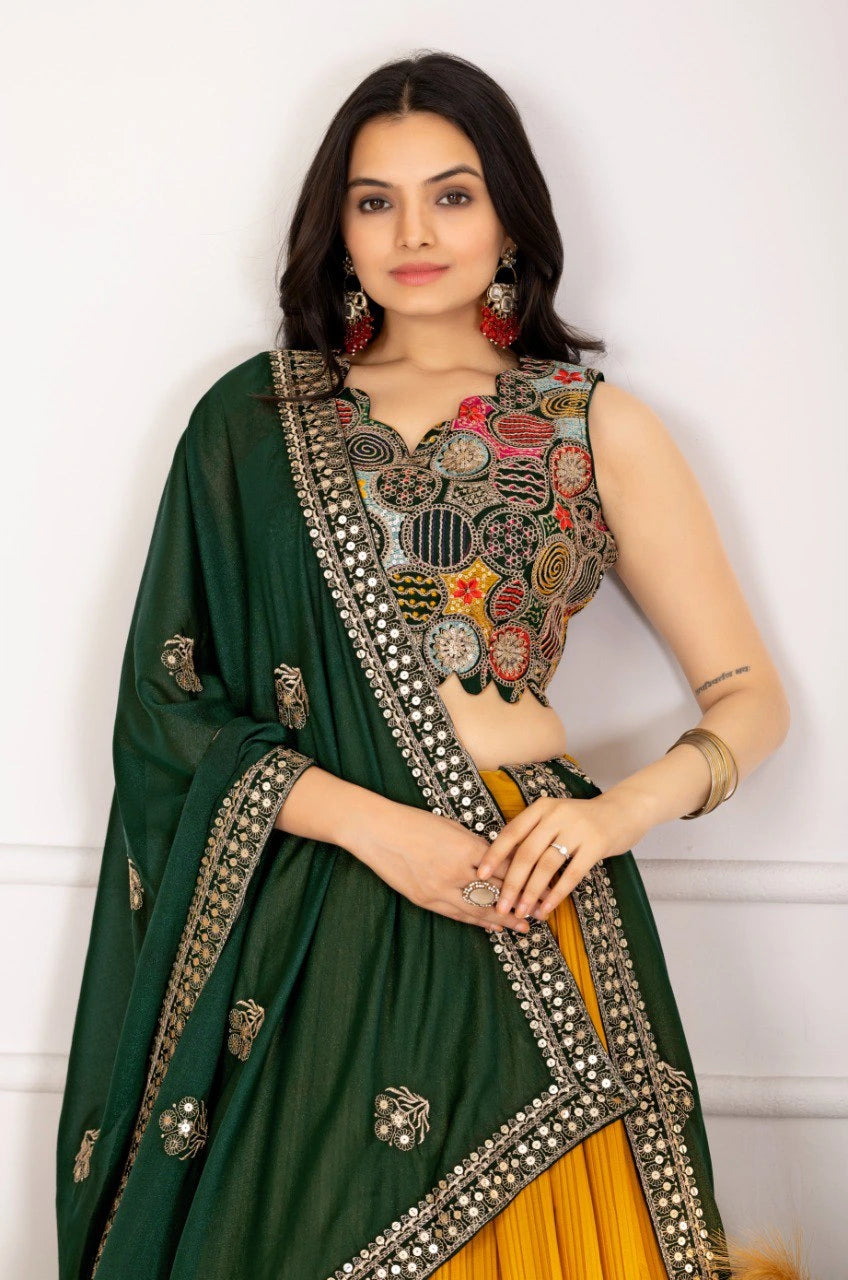 Woman wearing a green and yellow traditional outfit with intricate designs.