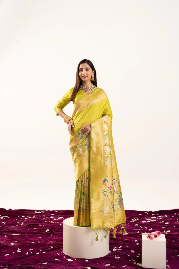 Woman wearing a yellow saree with a floral pattern on a white background