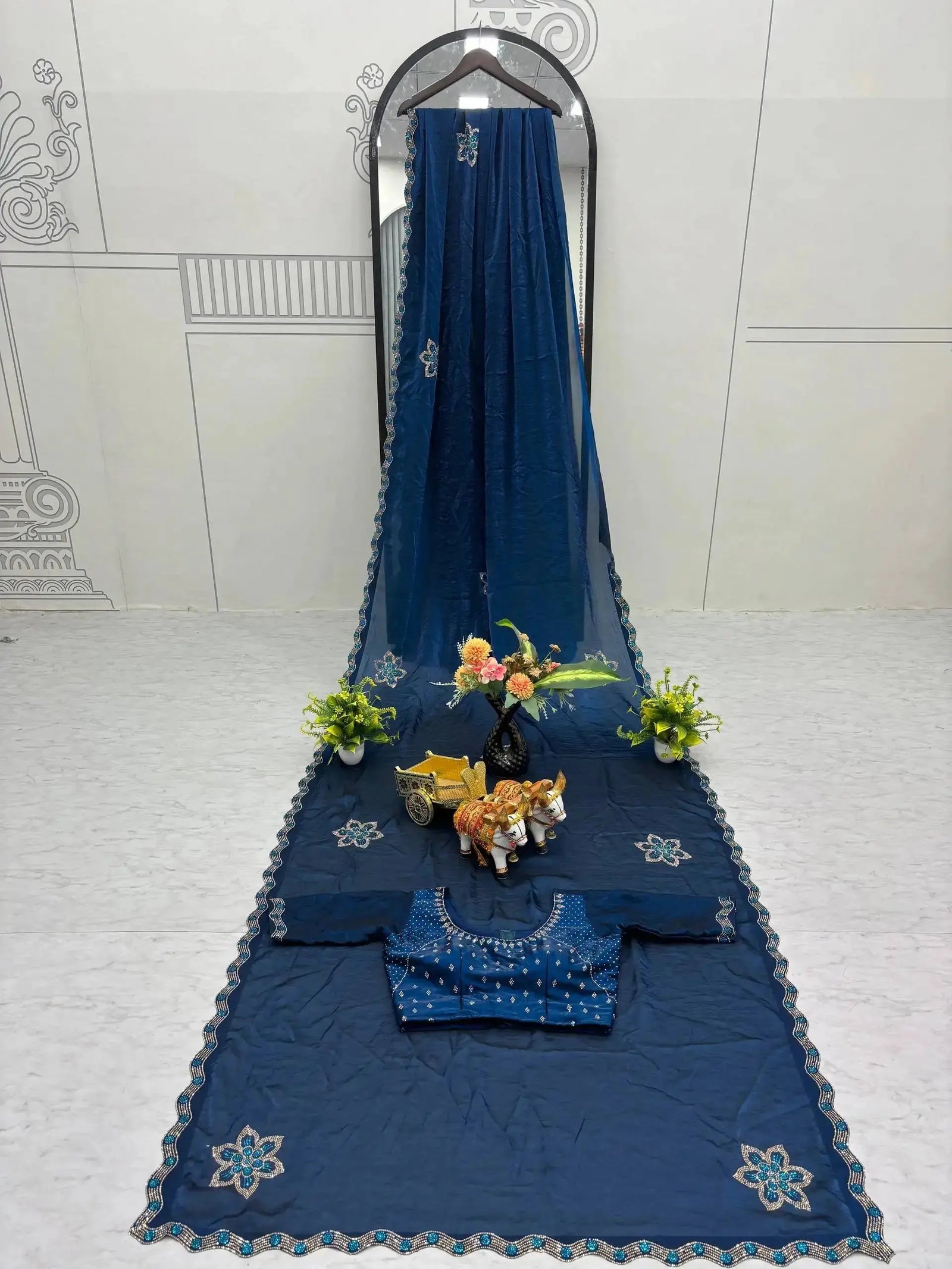 Navy Blue Diamond Work Saree flat lay with matching blouse piece on mirror stand