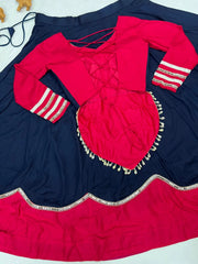 Flat lay showing back of pink lace-up choli and navy lehenga skirt with scalloped pink border