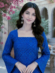 Woman in a blue dress with floral and architectural background