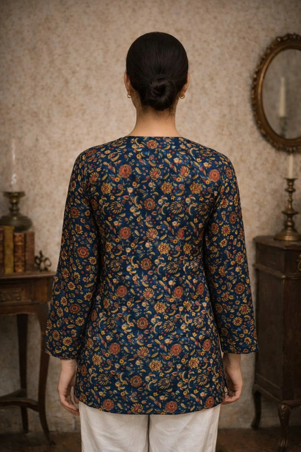 Person wearing a floral-patterned top in a vintage interior setting