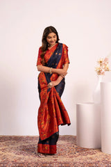 Woman wearing a traditional saree with a red and blue pattern on a white background