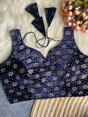 Blue floral patterned lingerie set on a textured surface with flowers.