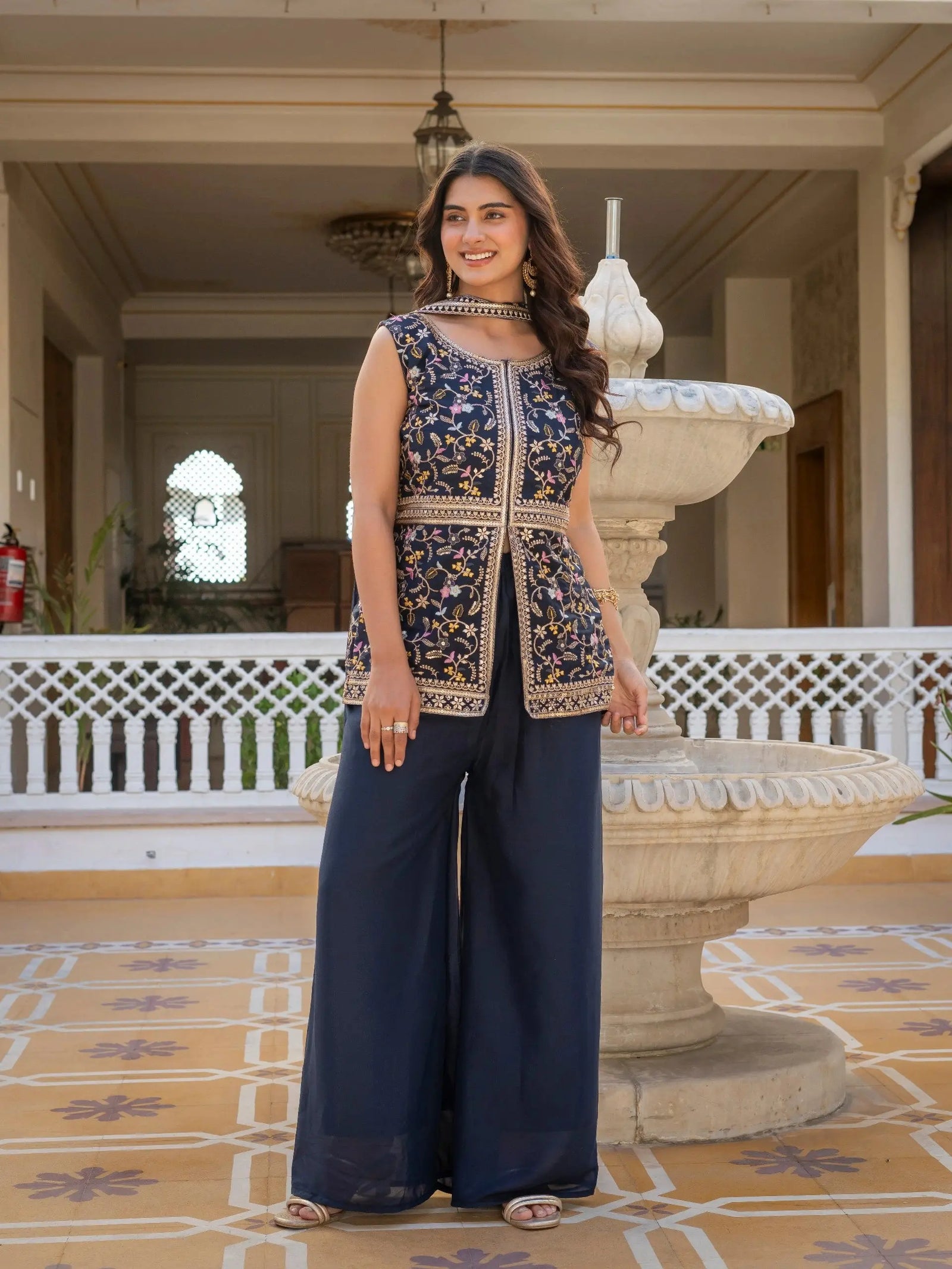 Stylish navy blue georgette suit with heavy embroidery on sleeves and hemline.