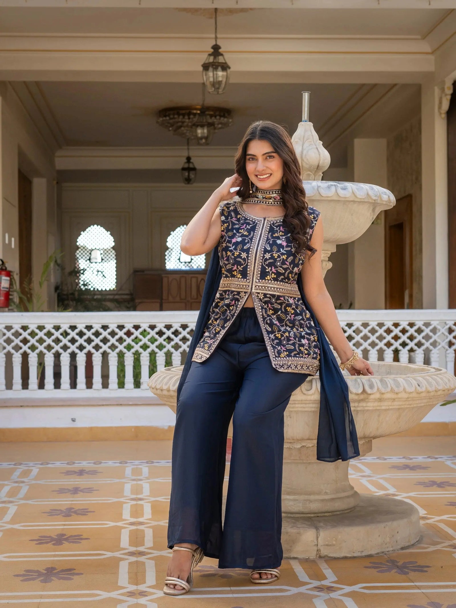 Navy blue embroidered georgette suit laid flat for product display.