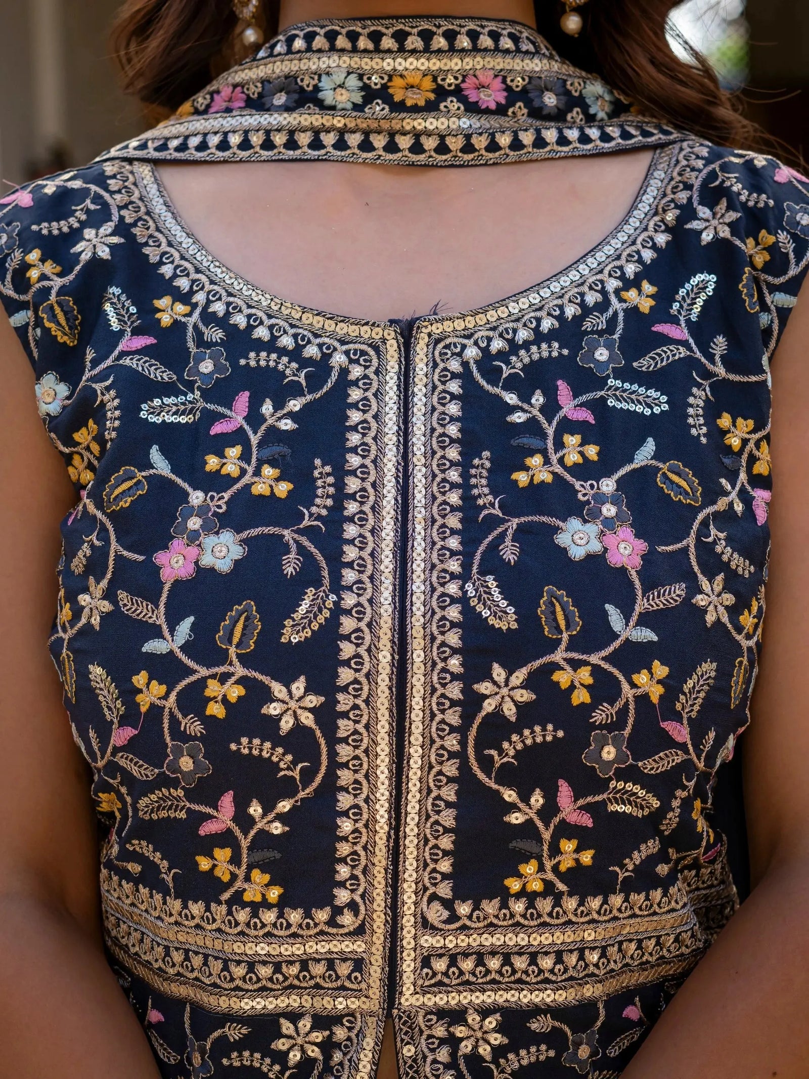 Navy blue georgette suit with intricate embroidery across bodice and sleeves.