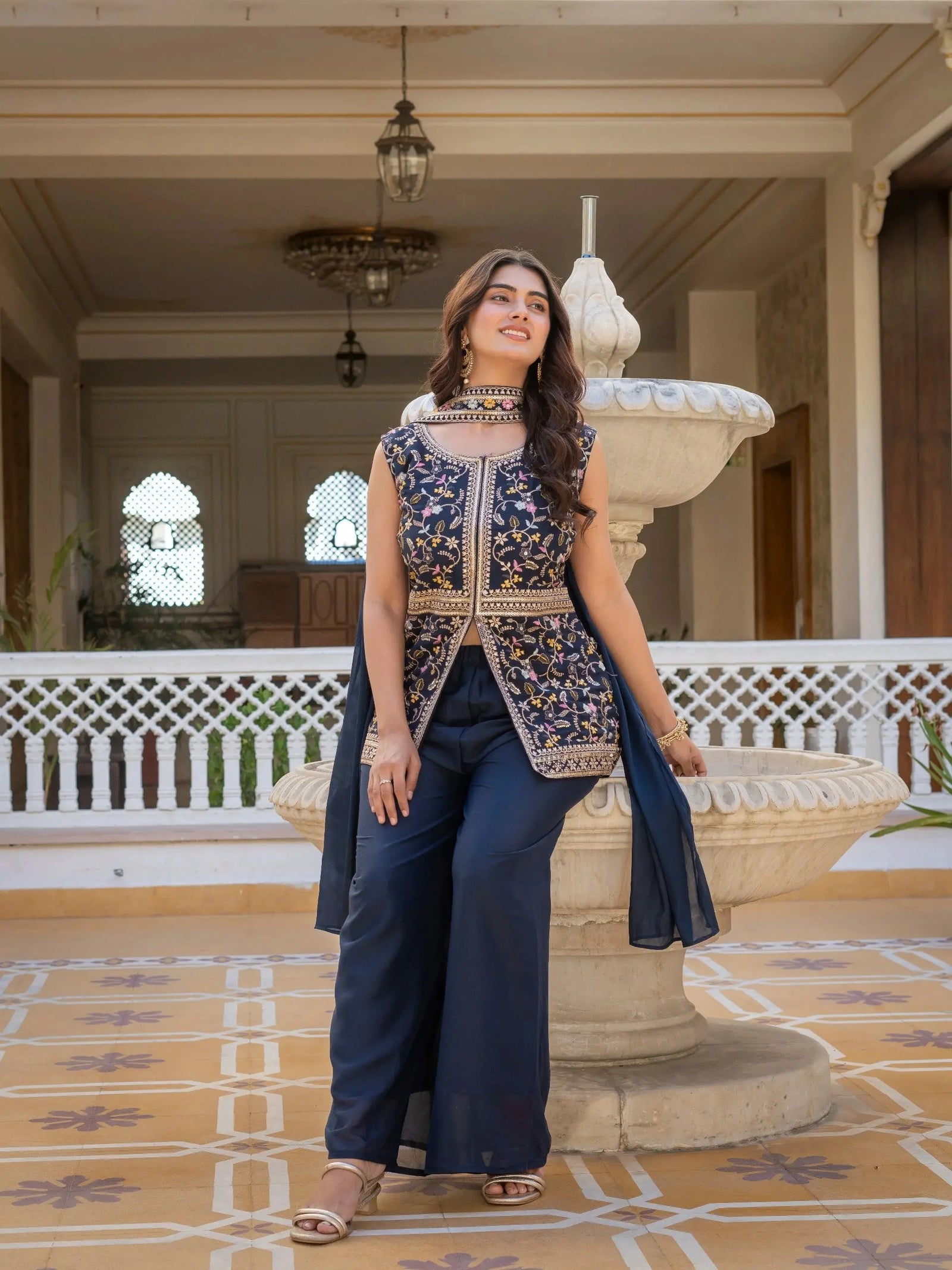 Traditional embroidered georgette suit in navy blue with ornate neckline design.