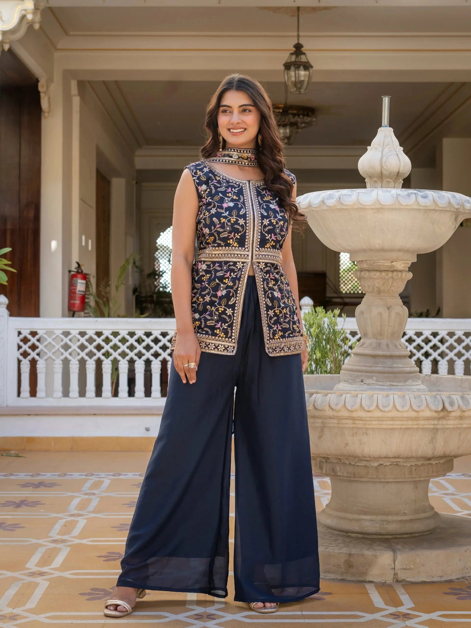Close-up of navy blue georgette fabric highlighting detailed embroidery work.