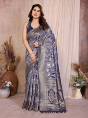 Woman wearing a blue and gray saree with a neutral background