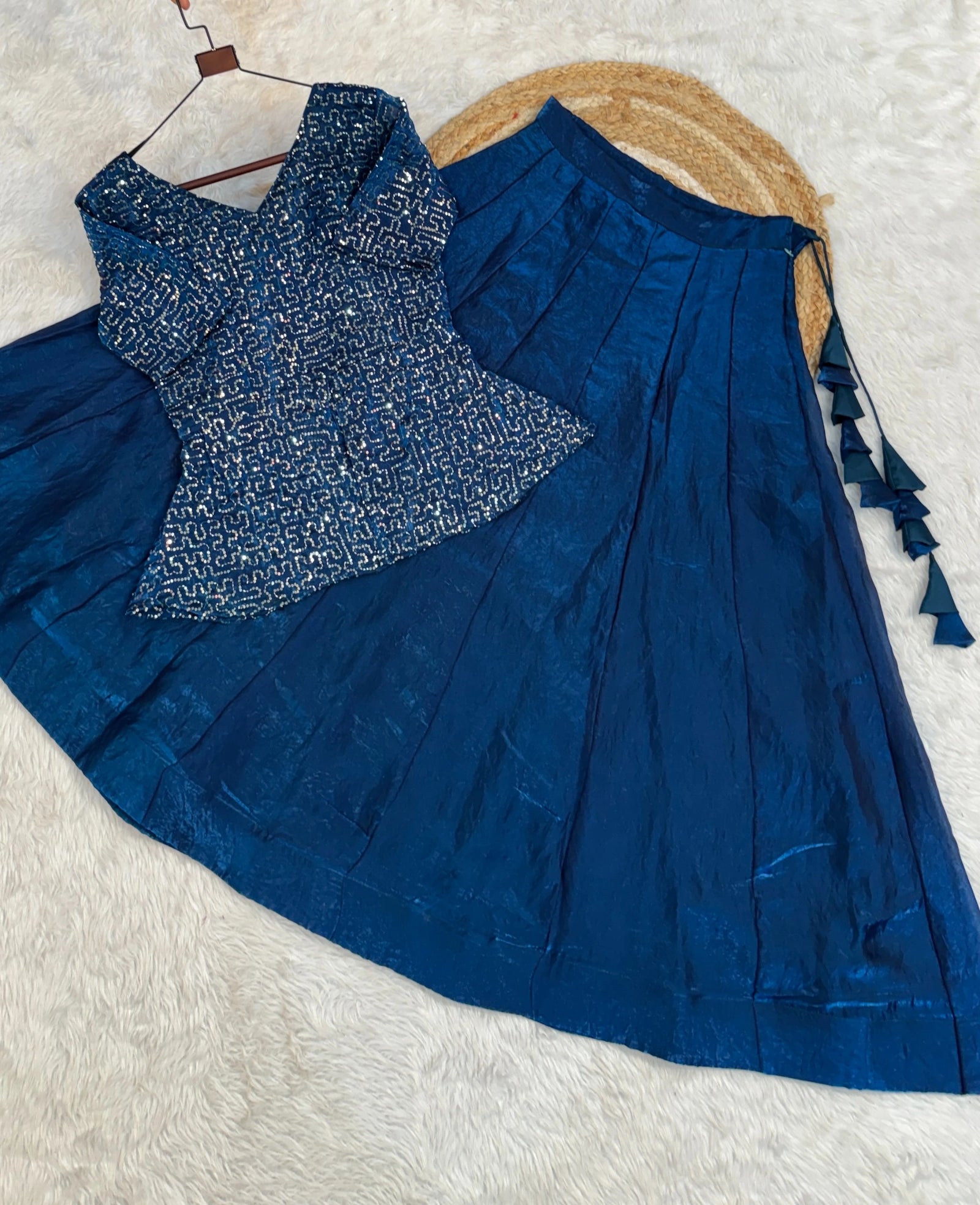 Blue patterned blouse with matching saree on a white background