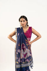 Woman wearing a navy blue saree with a white elephant design on a white background