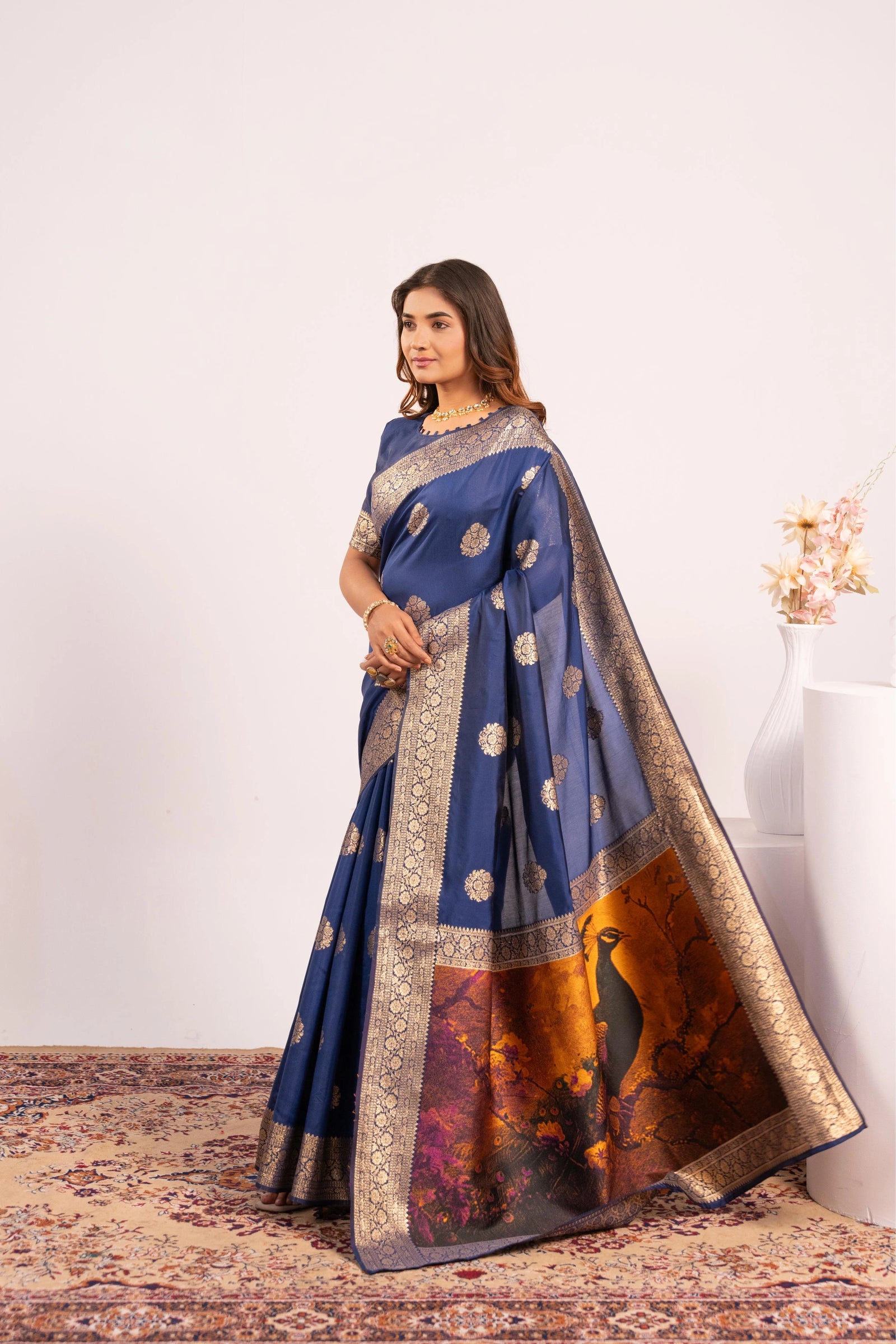 Woman wearing a blue saree with a white background