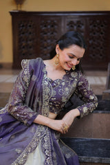 Woman in a traditional purple and gold outfit sitting on steps.
