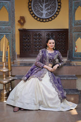 Woman in a traditional outfit sitting on steps with decorative wall and furniture in the background