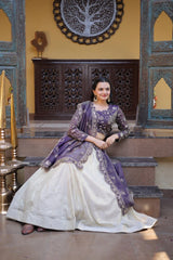 Woman in a traditional outfit sitting on steps with decorative wall and mirror in the background