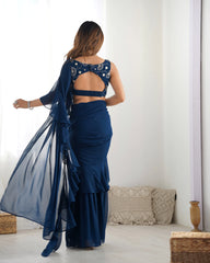 Woman in a blue saree with a white background